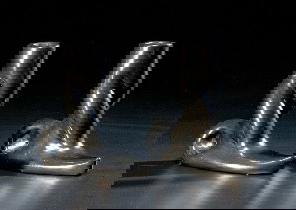 Teresita Naranjo Santa Clara Candlesticks : Teresita Naranjo Santa Clara Candlesticks Pair, base with pointed tip and loop for handle; candle holder with twisted stem; signed Teresita Naranjo Santa Clara Pueblo, height 5.75 in. x length 6.5 i