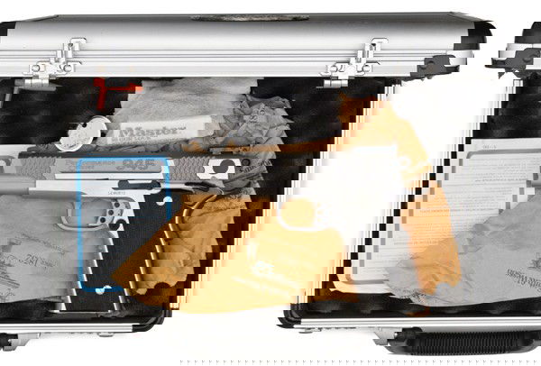 *Smith & Wesson Model 945 Performance Center Pist: *Smith & Wesson Model 945 Performance Center Pistol .45 ACP cal., 5" barrel, S/N LEW0872. Stainless steel finish, laminated wood grips, adjustable sights, aluminum "Performance Center" case.