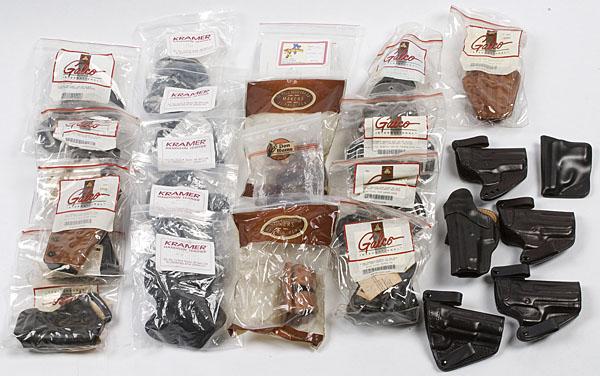 Box Lot of Twenty Five Leather Handgun Holsters : Box Lot of Twenty Five Leather Handgun Holsters Makers include Kramer, Galco, Don Hume, etc.