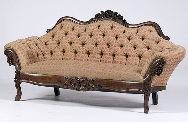 Victorian Upholstered Couch : Victorian Upholstered Couch American, 19th century. A Rococo Revival sofa with a carved crest, curvilinear back and arms, shaped and carved seat rail over cabriole legs featuring extensive floral, l