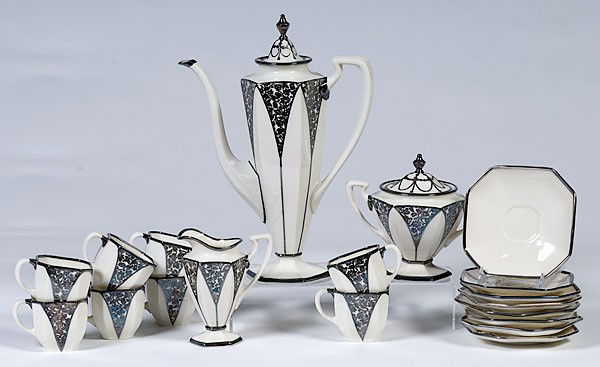American Belleek Silver Overlay Tea Set : American Belleek Silver Overlay Tea Set American, early 20th century. A sixteen-piece tea set in ivory porcelain with silver overlay. Includes a tapered tea pot, eight tea cups and saucers, creamer