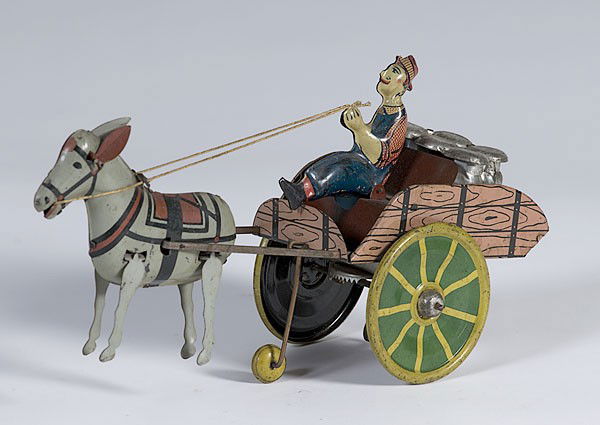 Wind-Up Hee Haw Balky Mule with Cart : Wind-Up Hee Haw Balky Mule with Cart American, early 20th century, tin lithograph wind-up Hee Haw Balky Mule toy with mule pulling a farmer and wagon loaded with milk cans, marked Hee-Haw on back of