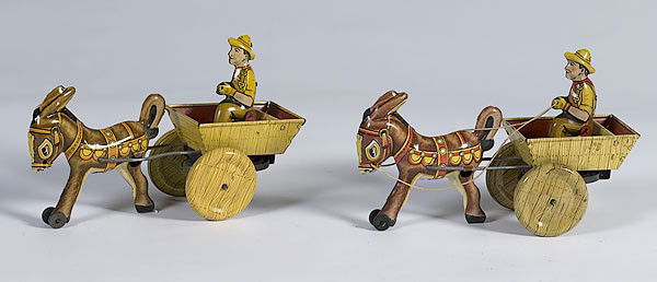 Pair of Marx Wind-Up Carts : Pair of Marx Wind-Up Carts Lot of 2. American, early 20th century, each is a Marx wind-up man with cart and one mule, with Marx toy mark stamped onto underbelly of the right side of the mule; lg. 8.