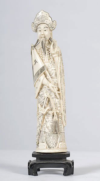 Carved Ivory of Japanese Emperor : Carved Ivory of Japanese Emperor Japanese, a carved ivory Emperor figure of a bearded man holding a flag with a sword at his feet, he wears a robe having incised cloud and dragon motif throughout, r