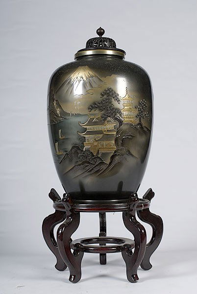 Oriental Lidded Jar with Stand : Oriental Lidded Jar with Stand Mixed metal jar with landscape depicting pagodas, boats, and a distant mountain, with wooden lid and stand;, jar ht. with lid 21.5, dia. 9.5 in.