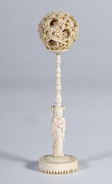 Ivory Puzzle Ball with Stand : Ivory Puzzle Ball with Stand Chinese carved ivory puzzle ball with stand, the multilayer ball pierced with writhing dragons and supported on a tall stand with turned spindle merging into a figure of