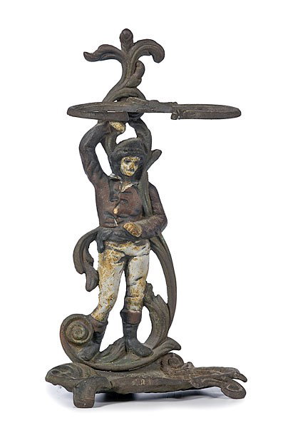 Cast Iron Figural Umbrella Stand : Cast Iron Figural Umbrella Stand 19th century, a cast iron and enameled stand in three pieces with scrolled arms, a jockey(?) with supporting arm connected to a drip pan of scrolls and scrolled feet