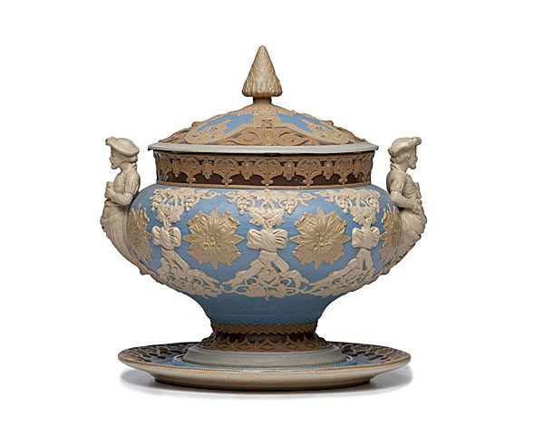 Mettlach Tureen and Underplate : Mettlach Tureen and Underplate German, a covered tureen and underplate attributed to Mettlach, the tureen with applied figural handles and having grape vine and medallion decoration, both with incis