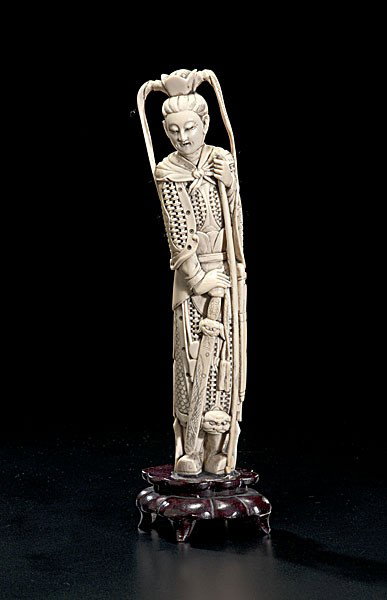 Chinese Carved Ivory Female Warrior Deity : Chinese Carved Ivory Female Warrior Deity Chinese, a carved and inked ivory tusk of a female warrior deity, on 20th century wooden stand; ht. 11 in.