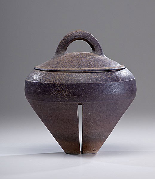 Masterworks: Karen Karnes Lidded Vessel : Karen Karnes (1925, USA) Lidded Vessel with Slit Foot ca 1988 Stoneware; ht. 13, wd. 11 in. A modestly scaled lidded vessel standing on a split base narrowing to a small foot with a dappled glaze of