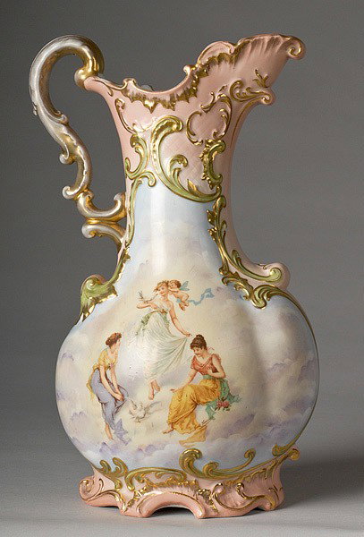 FINE HANDPAINTED CARLSBAD AUSTRIA PORCELAIN EWER : FINE HANDPAINTED CARLSBAD AUSTRIA PORCELAIN EWER Continental, a porcelain ewer decorated with Venus, Cupid and attendants on front and two frolicking cherubs on back. 14" high. Marked on base.