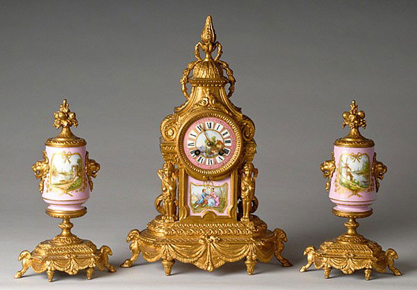 FRENCH THREE PIECE CLOCK SET : FRENCH THREE PIECE CLOCK SET French. A garniture set with Neo-classical porcelain faced clock mounted in a ormolu case. Signed F. Po'nnet with Columbus O. below (retail jeweler). Unsigned brass 8-da