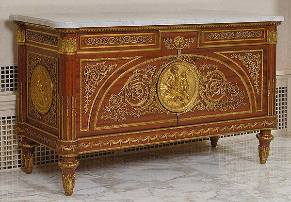 LOUIS XVI-STYLE MAHOGANY COMMODE: LOUIS XVI-STYLE MAHOGANY COMMODE 20th century, after Henri Reisener (1734-1806). With white marble top ormalou mounts and hardware, three drawers above two doors that open to reveal two over two int