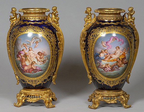 MONUMENTAL SEVRES URNS FOR KING LOUIS PHILIPPE: Made for Louis Philippe. 23" high on four scrolled feet with bronze figural mounts and rim, each with a different hand-painted allegorical scene representing the birth of Venus, each with a gilt flora