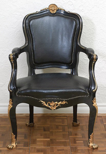 LOUIS XV-STYLE ARM CHAIR: LOUIS XV-STYLE ARM CHAIR In black leather upholstery with ebonized finish and bronze ormolu mounts. 21.5" wide. Seat 38.5" high.