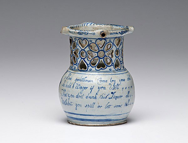 English Delftware Puzzle Jug : English Delftware Puzzle Jug English, probably Liverpool, 18th century. A Delftware puzzle jug with pierced neck above a globular body with verse; ht. 6.25 in.