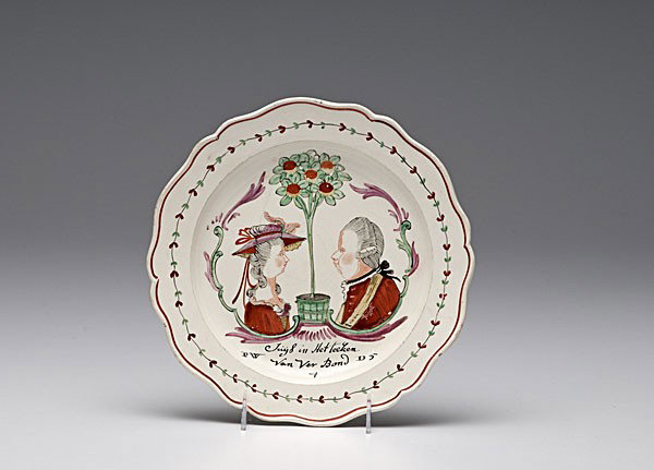 English Polychrome Creamware Plate : English Polychrome Creamware Plate English, ca 1790. A Dutch-decorated creamware plate with scalloped edge, central bust-length profile portraits of Frederica Sophia Wilhelmina and William V, flanki