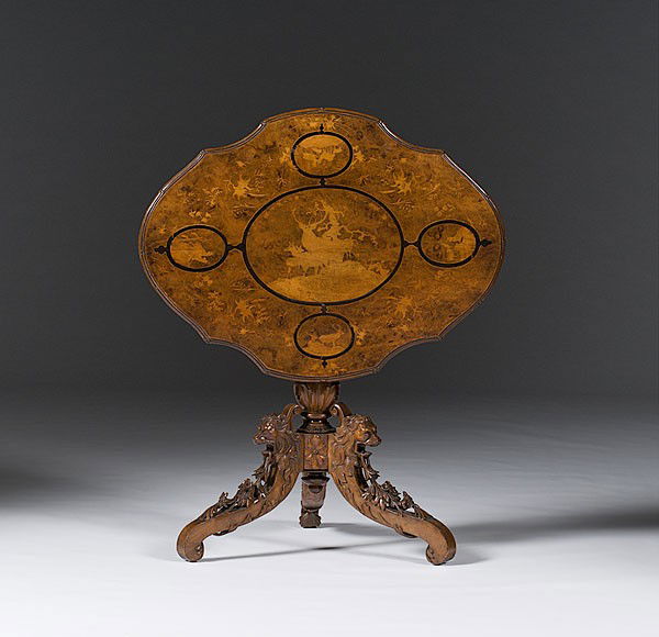 Continental Tilt Top Tea Table : Continental Tilt Top Tea Table German or Austrian, 19th century. A tilt top table in walnut having a marquetry inlaid top with a center reserve and four smaller reserves, all with deer and flowers,