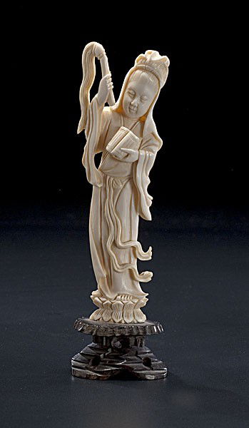 Carved Ivory Figure : Carved Ivory Figure Asian, a carved ivory figure of a goddess with flowing robes standing on a lotus blossom, on a 20th century stand; ht. 6 in.