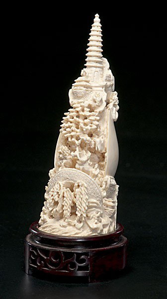 Chinese Carved Ivory Group : Chinese Carved Ivory Group Chinese, a carved ivory group featuring a mountainous landscape with figures and shell on reverse side, unmarked, on 20th century wooden stand; ht. 8 in. (including stand)
