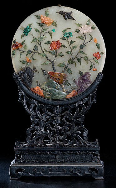 Chinese Jade and Hardstone Lamp : Chinese Jade and Hardstone Lamp Chinese, a jade and hardstone lamp on teakwood stand, with jade disk covered in carved jade, quartz and other hardstone applied carvings; oah 23.5 in, lamp dia. 13 in