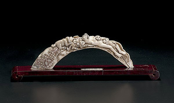 Japanese Carved Ivory Erotic Tusk : Japanese Carved Ivory Erotic Tusk Japanese, an elaborately carved and inked tusk with woman being consumed by dogs, signed on base, on a 20th century stand with signed ivory inset; tusk lg. 9, ht. 3