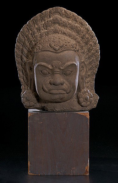 Kampuchea "Dvarapala" Head in Sandstone: Kampuchea Dvarapala Head in Sandstone Kampuchea (Cambodia), a Dvarapala or guardian's head in sandstone, on wood block plinth; ht. of head, 17 in.; together with wooden plinth, ht. 28 in.