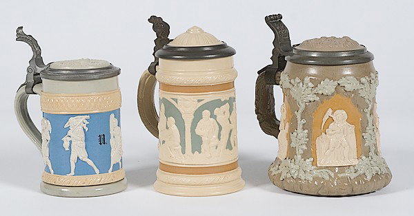 Mettlach Relief Molded Steins : Mettlach Relief Molded Steins German, ca 1900, three relief molded steins with figural decoration and pewter lids with inset medallions, including a .25L stein marked Villeroy & Boch / Mettlach / 17