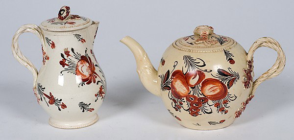 English Polychrome Creamware Creamer and Teapot : English Polychrome Creamware Creamer and Teapot English, a polychrome creamware covered creamer and teapot in the "King's Rose" pattern, both with a double-twist reeded handle with floral terminals