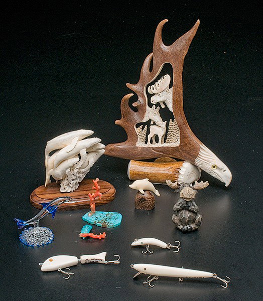 Ivory Wildlife Items, Plus : Ivory Wildlife Items, Plus an assembled group of nine wildlife items including two ivory marine animal carvings, three ivory fishing lures, a glass dolphin, two caribou carvings, and a coral piece; 