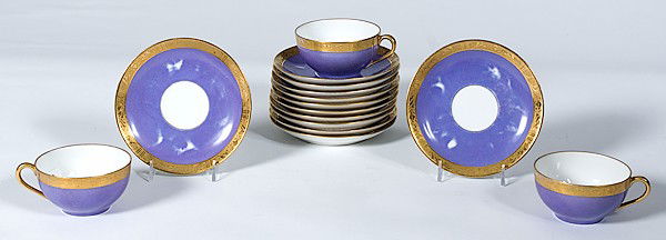 Porcelain Cups and Saucers : Porcelain Cups and Saucers 20th century, includes eleven cups and twelve saucers, all with purple and gold banded decoration, cups marked Hand painted / Nippon, saucers marked Ovington Bros / New Yo