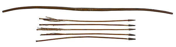 Plains Wooden Bow and Arrows : Plains Wooden Bow and Arrows lot of 6. Long bow with sinew-wrapped grip; notched grips and remnants of pigment, length 44 in.; AND five metal-tipped arrows; two arrows with Rosebud Sioux inked on bl