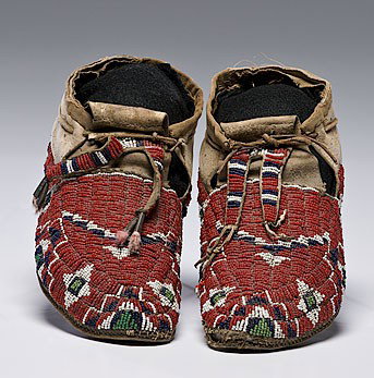 Sioux Beaded Hide Moccasins : Sioux Beaded Hide Moccasins thread and sinew-sewn beaded using colors of red, white, dark blue, and pea green; bifurcated tongues finished with tin cones and dyed feathers, length 10 in. ca 1900
