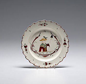 English Polychrome Creamware Plate : English Polychrome Creamware Plate English, 18th century, a Dutch-decorated polychrome creamware plate, having a scalloped edge and with a central figure with the initials V.H.; dia. 9.5 in.