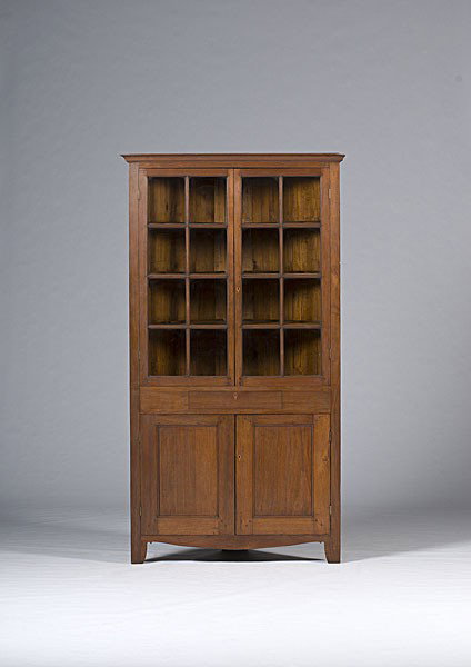 Ohio Corner Cupboard : Ohio Corner Cupboard Ohio, 19th century, a corner cupboard in walnut with pine secondary having pinned construction, with a molded cornice over eight-lite glazed doors, one long drawer over two door