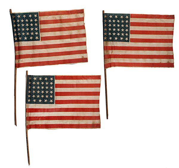 Group of 34-Star American Parade Flags : Group of 34-Star American Parade Flags Lot of 3 glazed cotton, printed parade flags, each with 34 stars configured in 5/6/6/6/6/5 horizontal rows, 7.75 x 10.75 in., each mounted on wooden dowel. Kan
