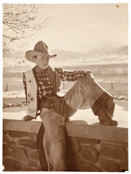 Charles J. Belden Photograph of a Cowhand : Charles J. Belden Photograph of a Cowhand Silver gelatin photograph, unmarked, but attributed to Charles Belden, depicting a well-dressed, female cowhand in a relaxed pose, with the open range at he