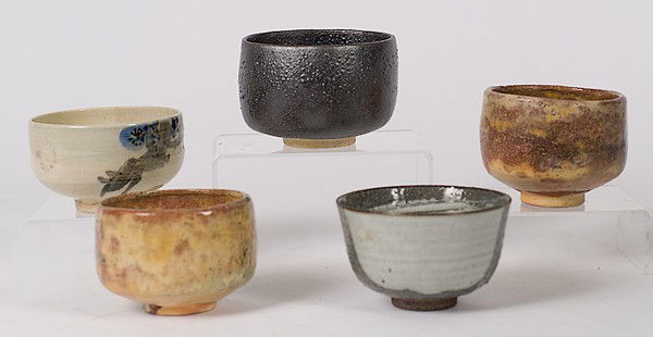 Japanese Tea Bowls : Japanese Tea Bowls Japanese, an assembled group of five tea bowls including a pair of redware tea bowls in a polychrome glaze with stamped mark, an unmarked Raku tea bowl, an unmarked redware tea bo