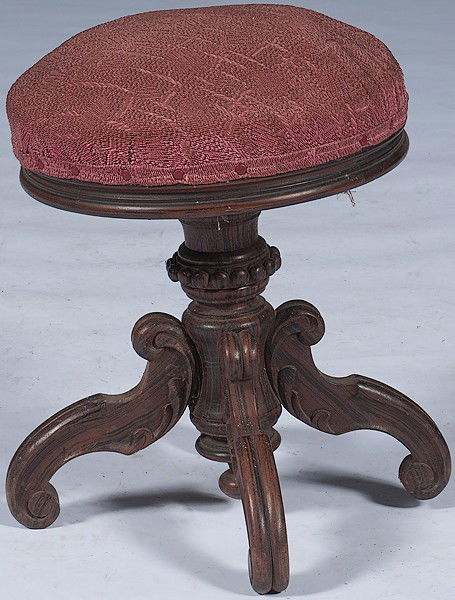 Victorian Organ Stool : Victorian Organ Stool American, a Victorian organ stool in rosewood with round upholstered seat over a carved pedestal, on four arched legs; ht. 20.5 in.