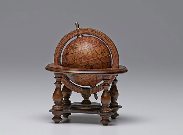 Italian Terrestrial Globe : Italian Terrestrial Globe Italian, 20th century, a replica of an antique terrestrial globe on a wooden stand, with sticker Olde World Globe Made in Italy on bottom; ht. 7 in.