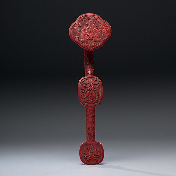 Chinese Cinnabar Ruyi Scepter : Chinese Cinnabar Ruyi Scepter Chinese. A carved cinnabar ruyi scepter, the head has immortals and children in a garden setting; the arched shaft is carved with a bat and two fish surrounded by flora