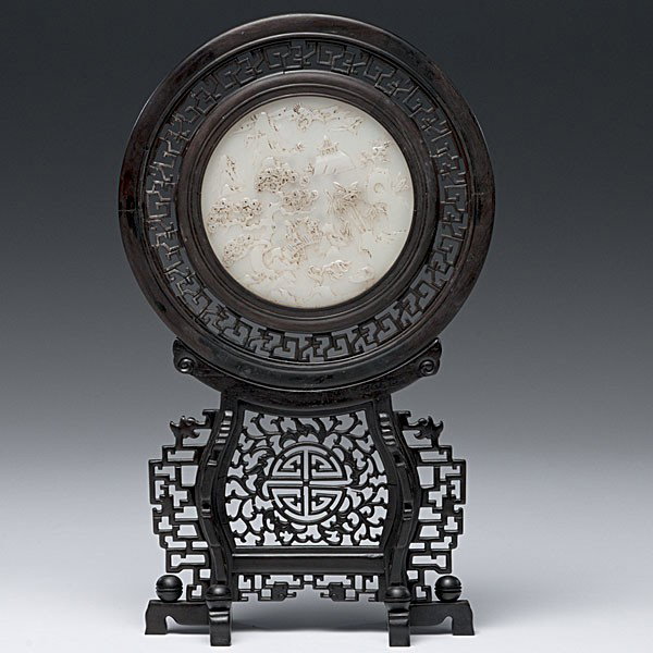 White Jade Screen : White Jade Screen Chinese, a round white jade screen with one side depicting a carved figure and phoenix in a mountainous landscape and the other side with overglaze gold text, all housed in a pierc