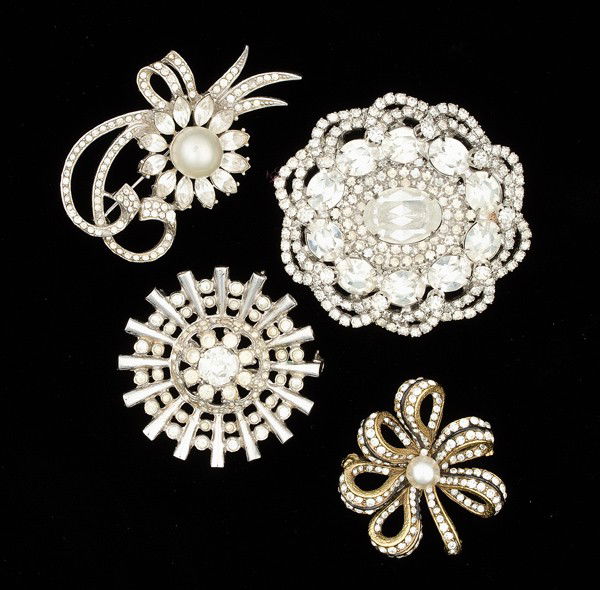 Kramer, Coro, Hattie Carnegie, Benedikt Costume Jew: A Kramer oval brooch, a Coro brooch, a Hattie Carnegie faux pearl, enamel and gold gilt brooch, a Benedikt faux pearl brooch; all signed pieces are stamped.