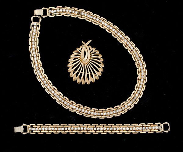 Kafin &Trifari Costume Jewelry Collection : A Kafin tennis-style bracelet, a Trifari brooch and a Kafin strand necklace; all signed pieces are stamped.