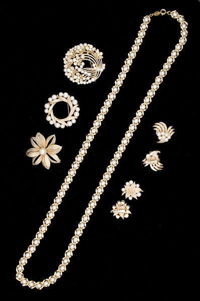Trifari, Giovani & Napier Costume Jewelry Collectio: A Trifari brooch with faux pearls, a Trifari brooch with faux pearls, a Giovani brooch with faux pearls, two pair of Trifari ear clips with faux pearls and a Napier Opera Length faux pearl necklace; a