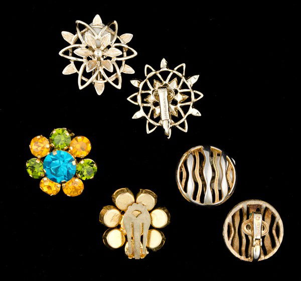 Trifari, Sarah Coventry & Unsigned Ear Clips Collec: A pair of Trifari ear clips, a pair of Sarah Coventry ear clips and a pair of unsigned Austrian rhinestone ear clips; all signed pieces are stamped.