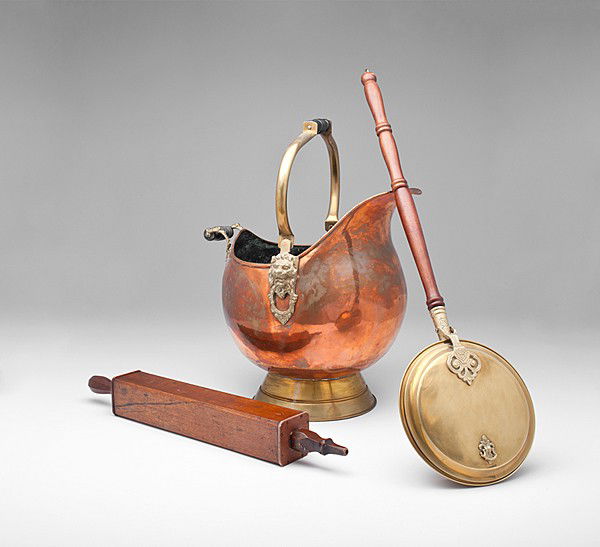 English Copper Coal Hod and Brass Fireplace Access: English Copper Coal Hod and Brass Fireplace Accessories English, 19th century, a riveted copper coal hod with brass foot and handle, a brass bed-warmer with wooden handle, and a wooden bellows; coal