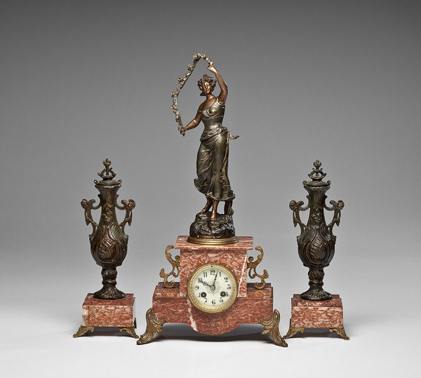 French Clock Garniture Set : French Clock Garniture Set French, early 20th century, a three-piece garniture set by Japy Freres, the clock and side pieces surmounted by spelter forms, the figure marked Epoque Fleurie, and with e
