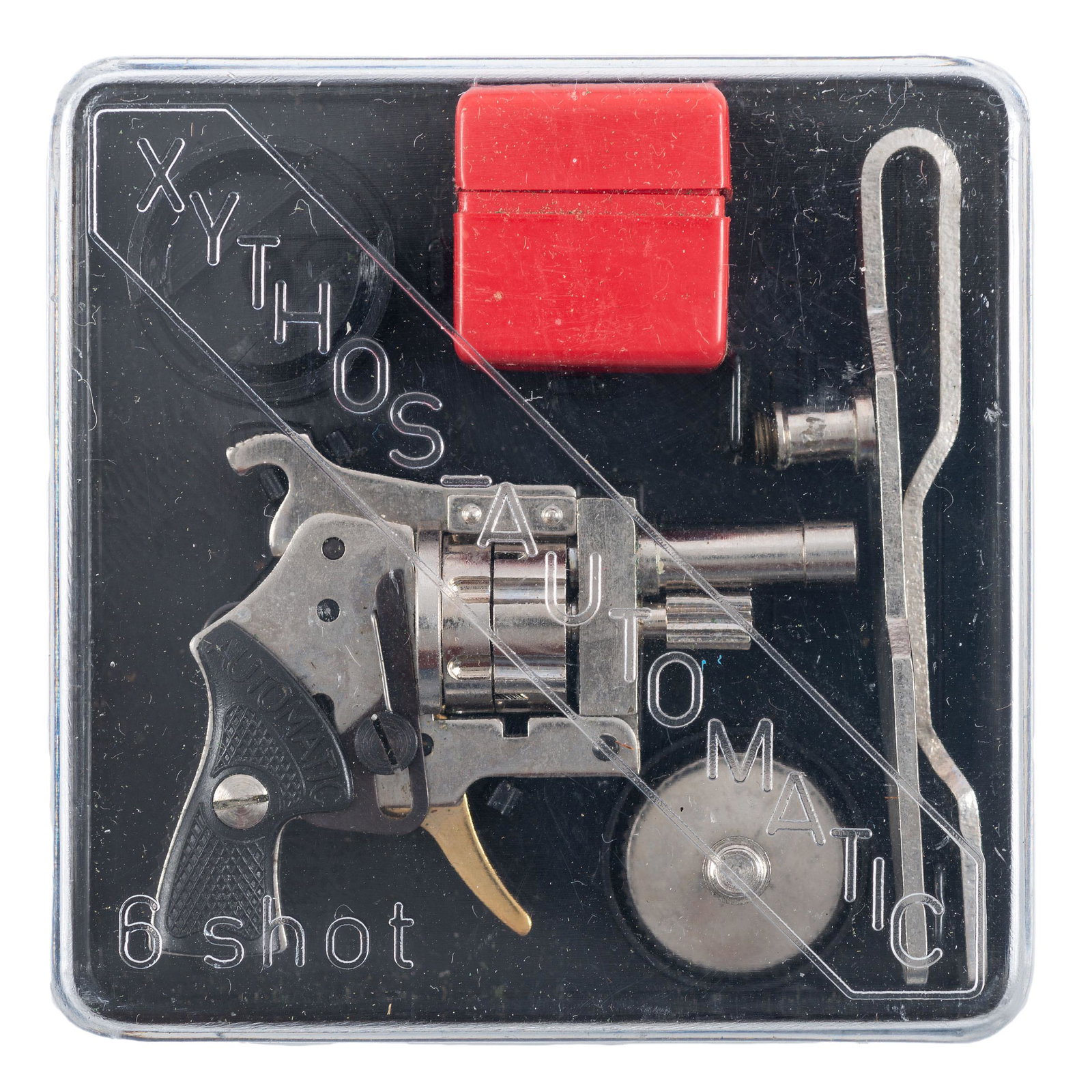 * Xythos Automatic 2mm Pinfire Revolver with Blank Rounds, Tools, and Case: 2mm Kolibri. .5" barrel length. SN: NSN. Nickel finish with gold trigger. Black synthetic grips are checkered, with left grip showing XYTHOS banner and right grip showing AUTOMATIC banner. Top break d