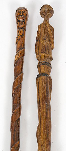 Folk Art Carved Figural Canes : Folk Art Carved Figural Canes American, early 20th century. Two carved wood canes, each having carved coiled snake and carved head to top; largest lg. 39 in.